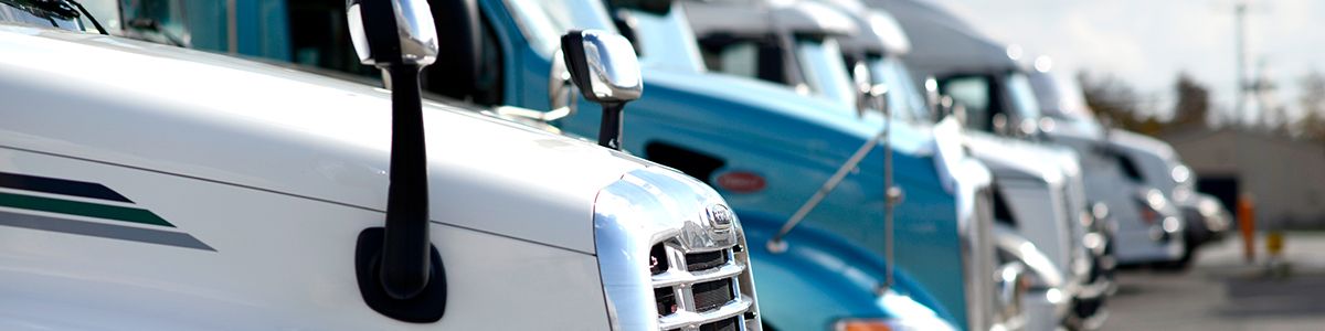 A row of semi truck cabs parked