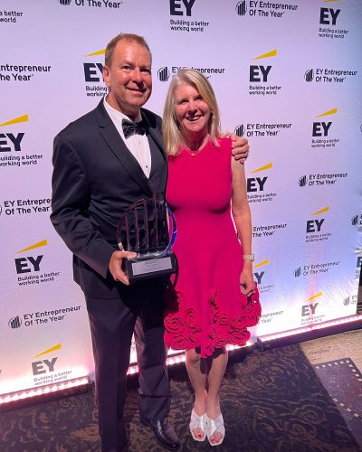 Tom Fogarty and his wife posing for photo with award