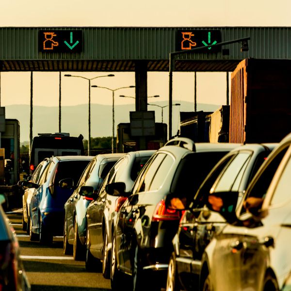 Vehicles entering a toll plaza and booths